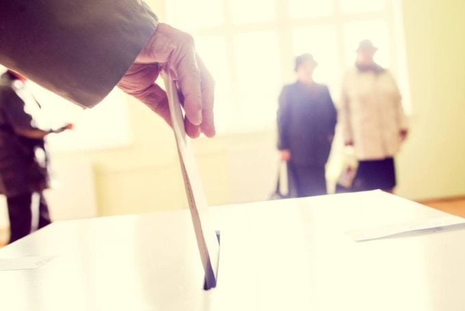 Hand Of A Person Casting A Ballot At A Polling Station