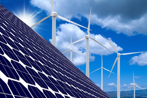 Solar Panels And Windmills With Blue Sky