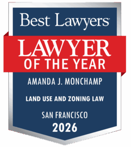 A Blue And Silver Badge Reading &Quot;Best Lawyers Lawyer Of The Year,&Quot; Awarded To Amanda J. Monchamp For Land Use And Zoning Law In San Francisco, 2026.